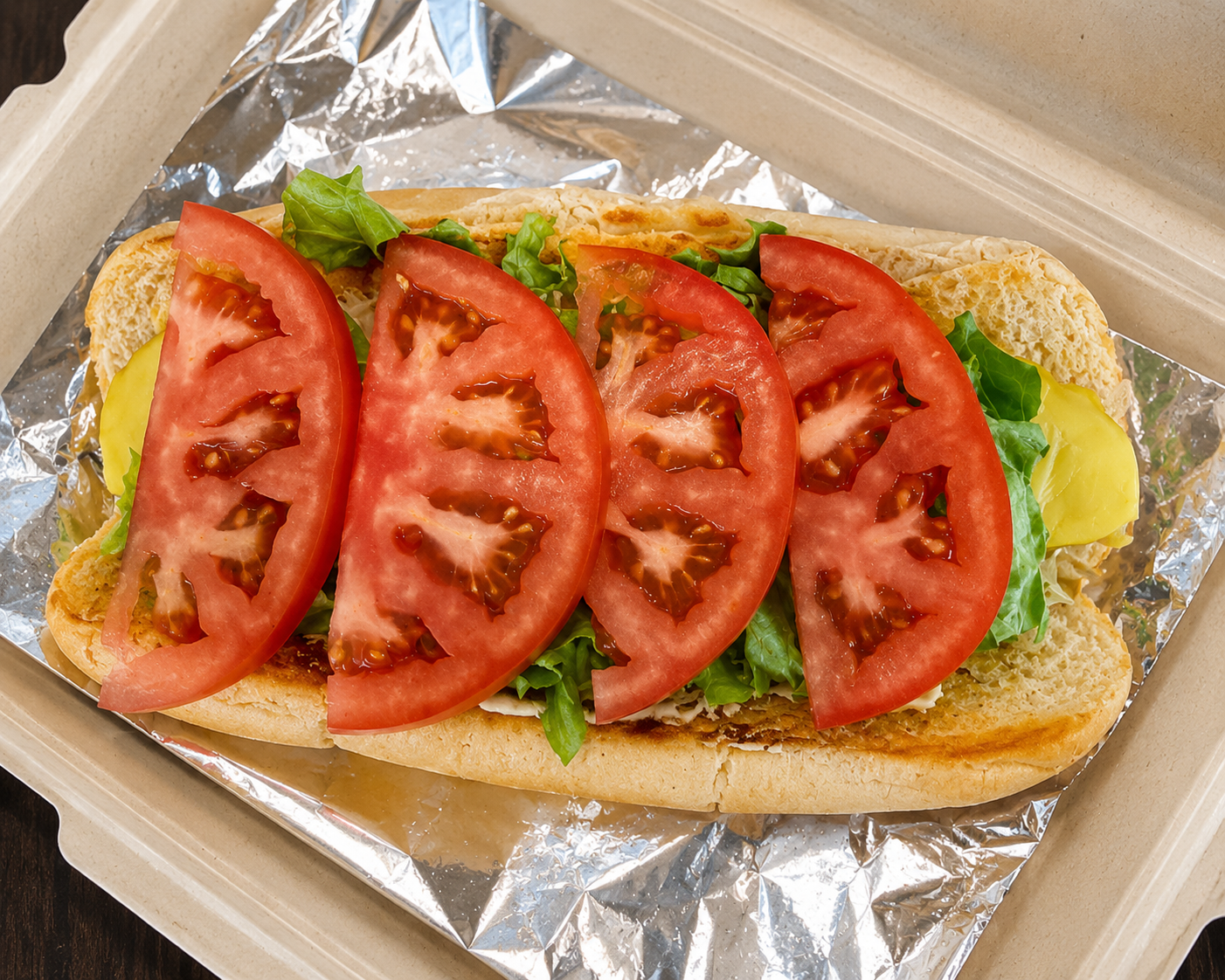 Vegan sub with fresh tomato, lettuce and cheese