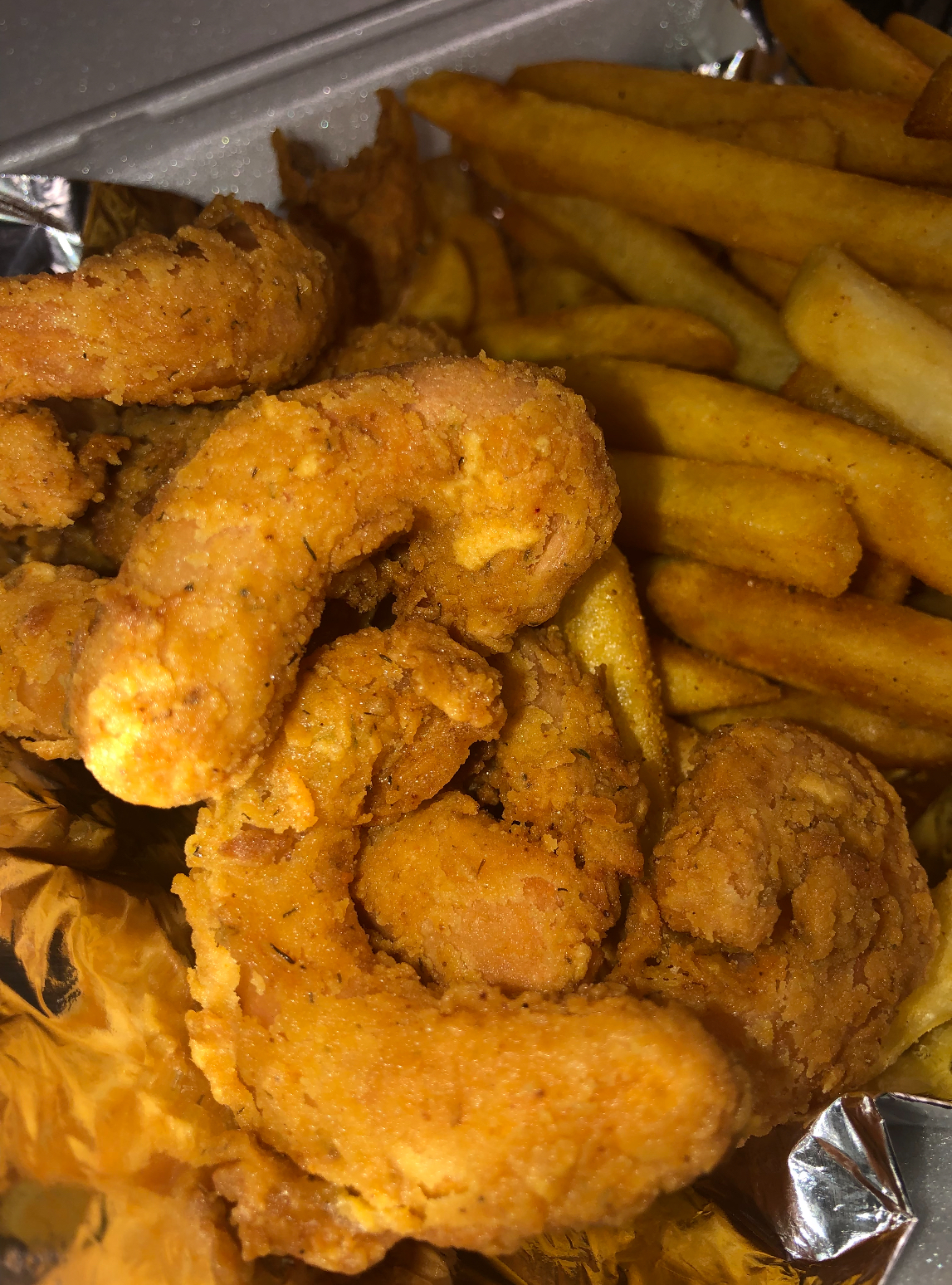 Golden vegan chicken tenders with seasoned fries