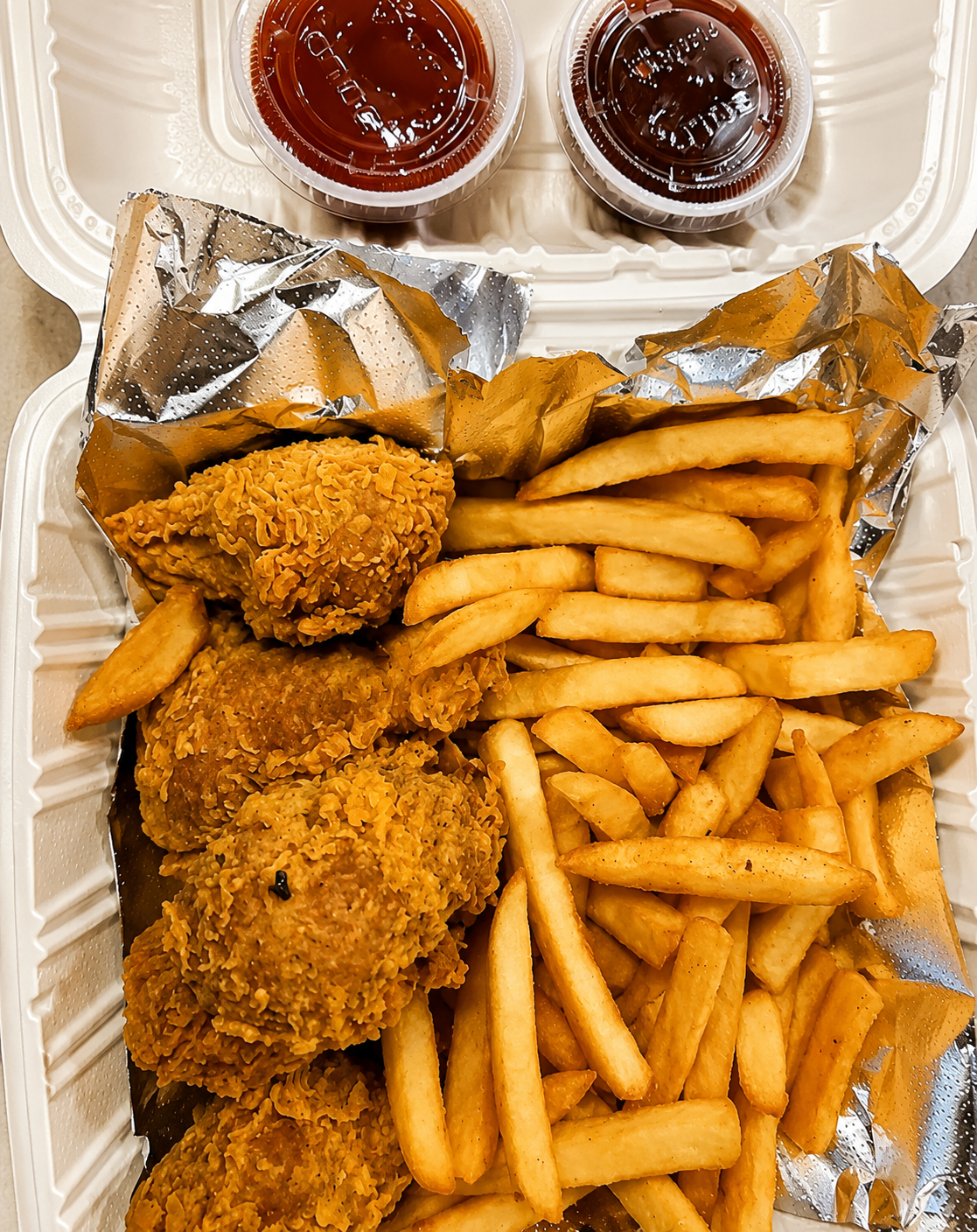 Crispy vegan flaming tenders with fries and dipping sauces