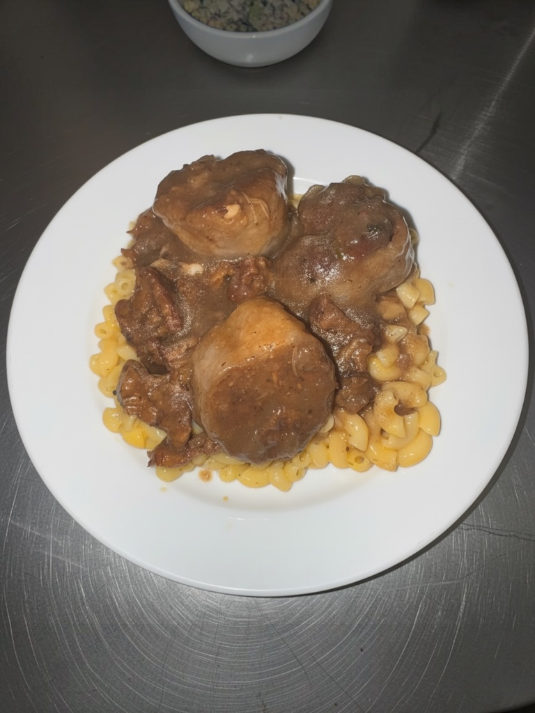 Smothered vegan chops over mac and cheese